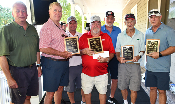 a group of people with golf awards from NCMCA